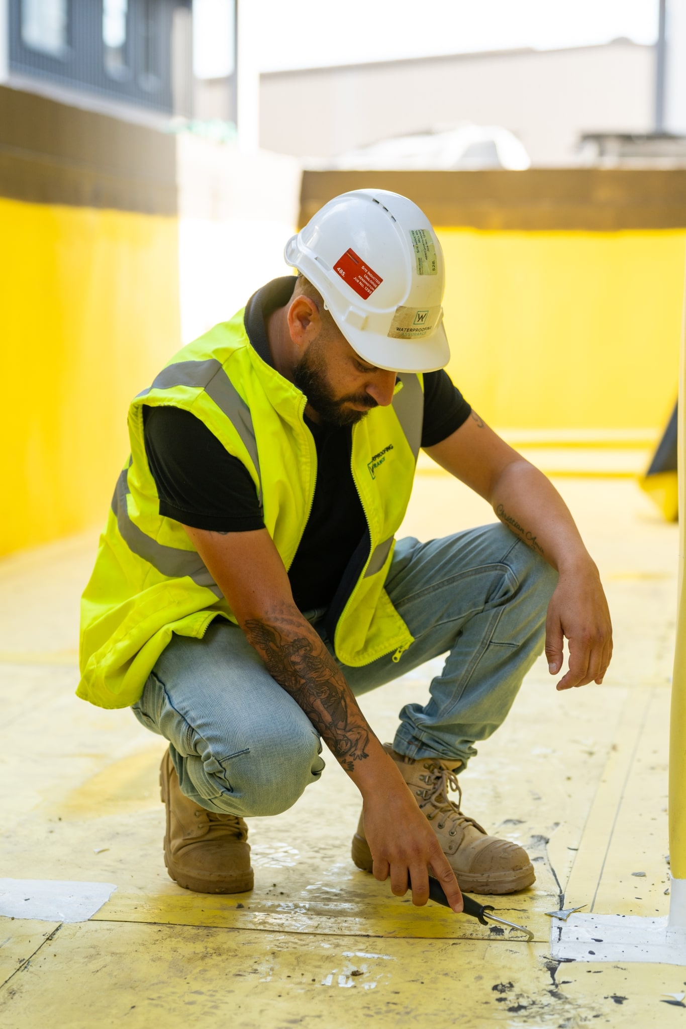 A man wearing a waterproof yellow vest.